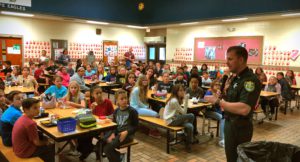 Sheriff talking to students in lunch room