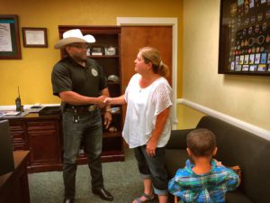 Sheriff and woman shaking hands